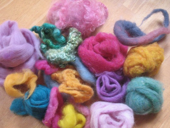 First you need a selection of wool "roving".  It is basically fluffy un-spun dyed wool fiber.  This is the color palette we used.